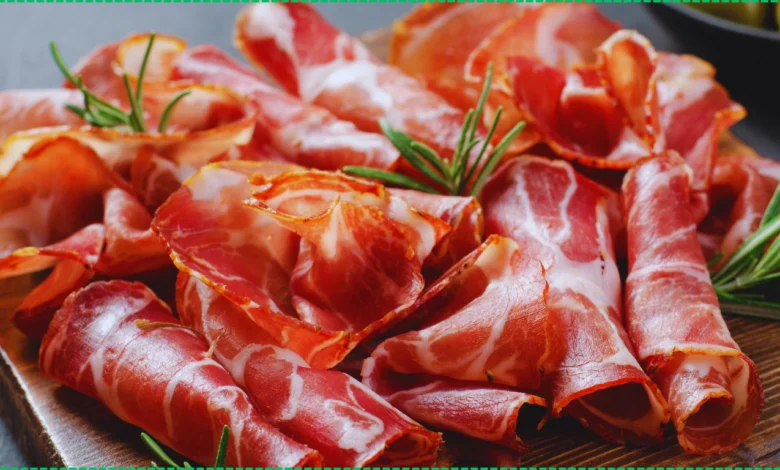 Crispy, golden-brown beef bacon strips on a wooden cutting board