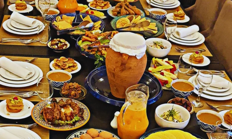 A beautifully arranged Moroccan feast featuring couscous, tagine, and traditional mint tea, served with fresh herbs and spice